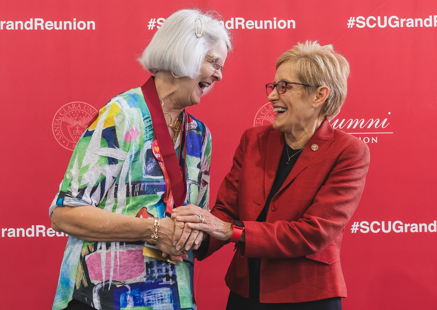 President Sullivan shaking hands with an alumna
